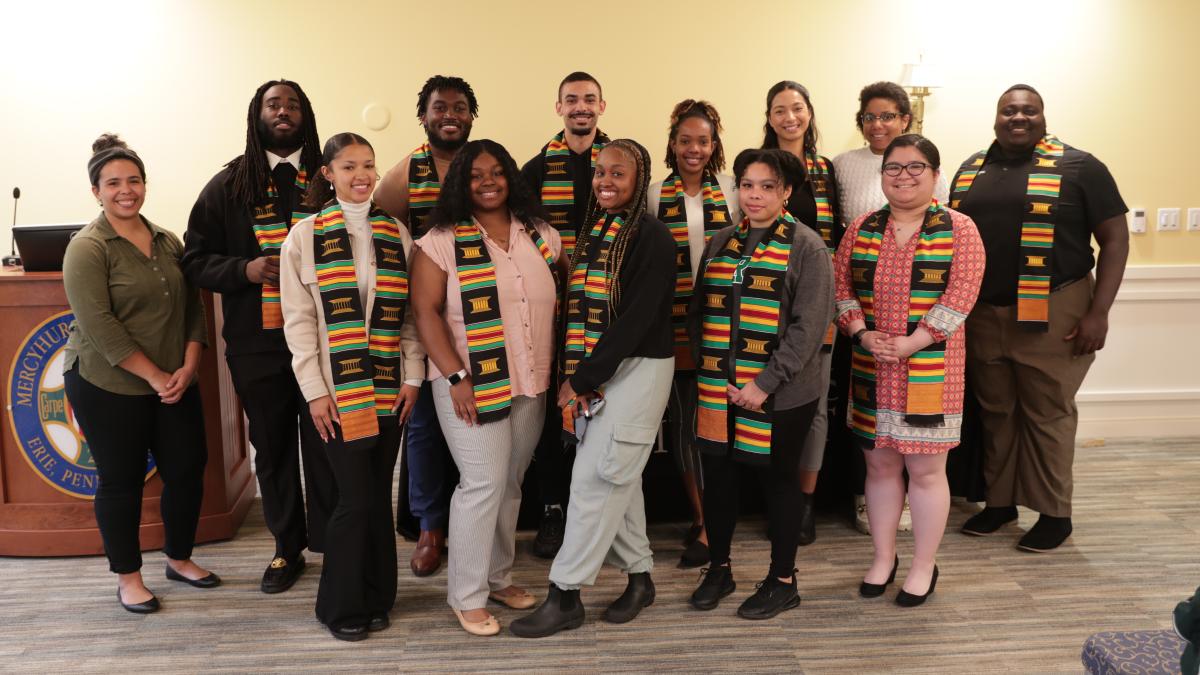 a group of mercyhurst students wear traditional kente stoles