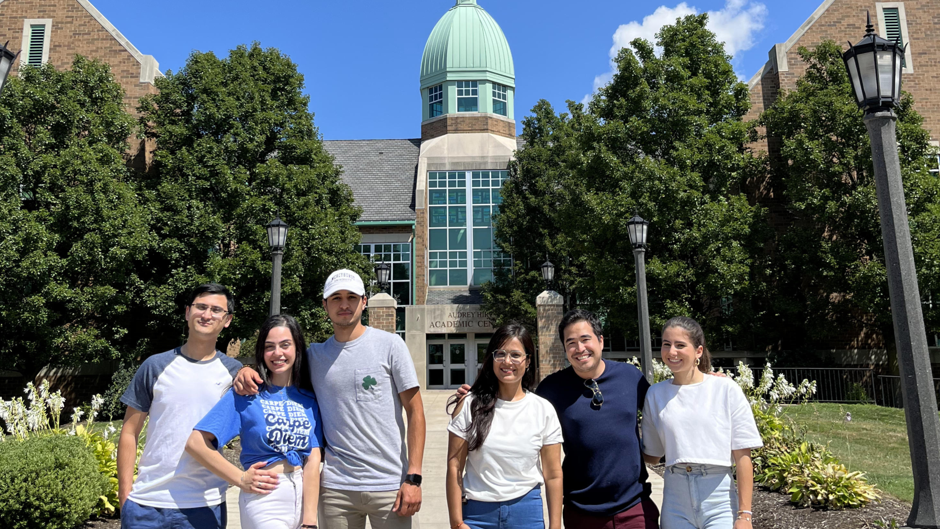 group of international students pose in front of Hirt Academic Building