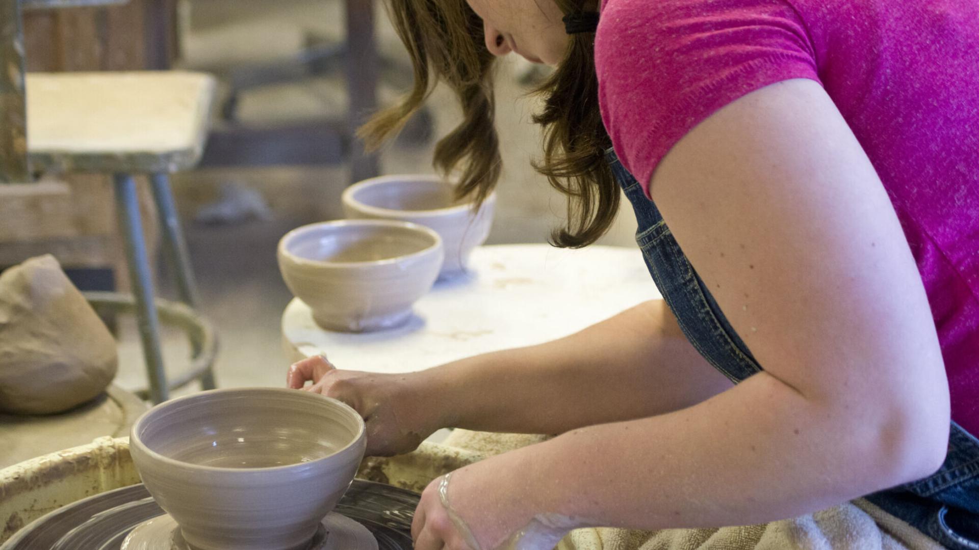 Ceramic student making shaping clay
