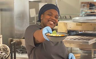 Dining Worker serving food with a smile
