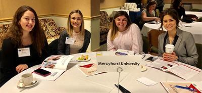 Four female Human Resource Management students at conference dining table