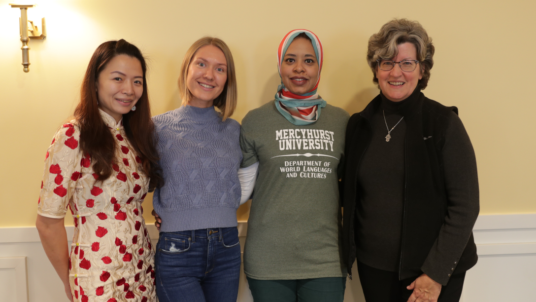three fulbright scholars students pose with a professor