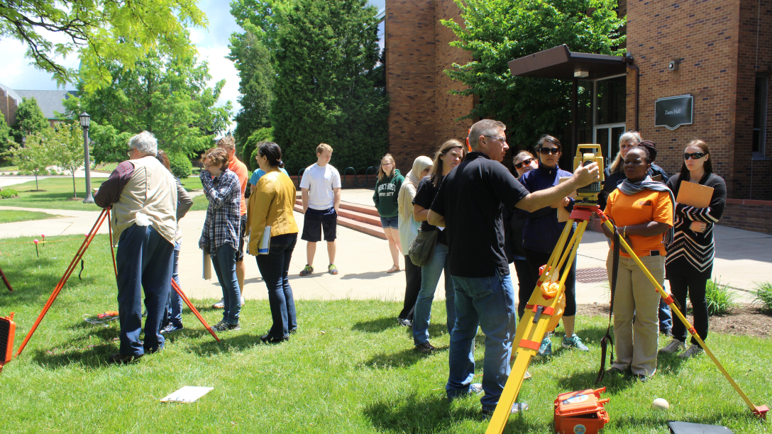 a group of forensic science students outside taking measurements