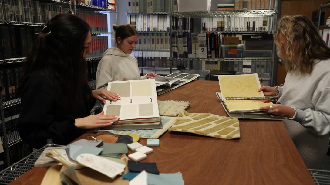 three female students work in the interior design materials lab
