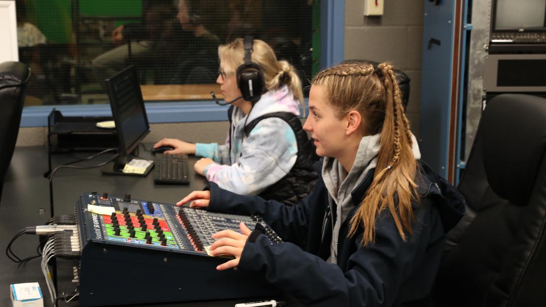 two female students record audio