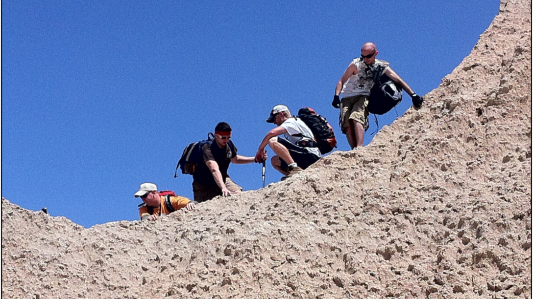 a group of geology students climb a mountain