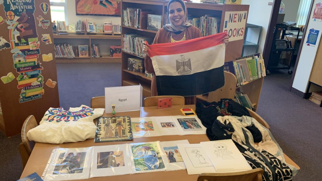 woman with flag and cultural items in library