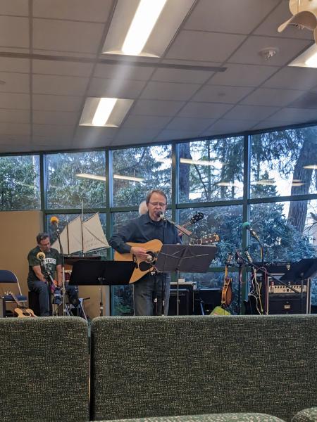 a mercyhurst faculty member plays guitar